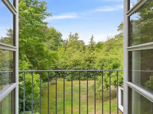 una ventana abierta con vistas al jardín en Holiday Home Rina - 250m from the sea in Bornholm by Interhome, en Hasle