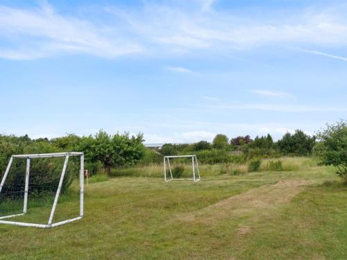 two soccer nets in a field with trees in the background at Holiday Home Aurore - 1-3km from the sea by Interhome in Fårevejle