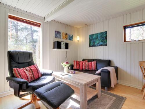 a living room with two chairs and a table at Apartment Kolja - 3km from the sea in Western Jutland by Interhome in Blåvand