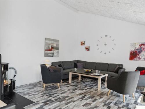 a living room with a couch and chairs and a table at Holiday Home Josina - 675m from the sea in Sealand by Interhome in Tjørneholm