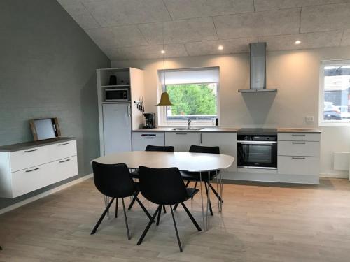 a kitchen with a table and chairs in it at Apartment Esger - all inclusive - 900m from the sea by Interhome in Blåvand