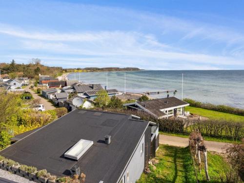 an aerial view of a house next to the ocean at Holiday Home Steen - 30m from the sea in Funen by Interhome in Vejstrup