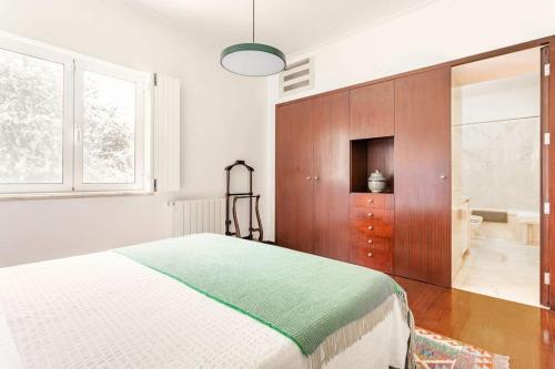 a bedroom with a bed and a sliding glass door at Casal das Aveleiras in Cartaxo