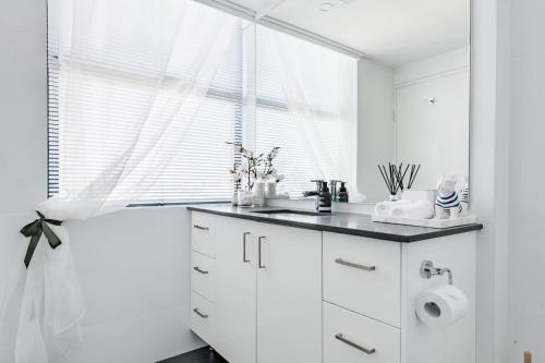 a white kitchen with a sink and a window at Abwechslungsreiche Unterkunft mit charmanten Flair in Hilden