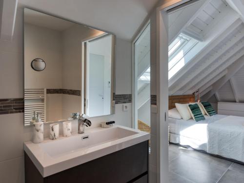 a bathroom with a sink and a bed and a mirror at Appartement Saint-Martin , 4 pièces, 8 personnes - FR-1-734-2 in Saint Martin