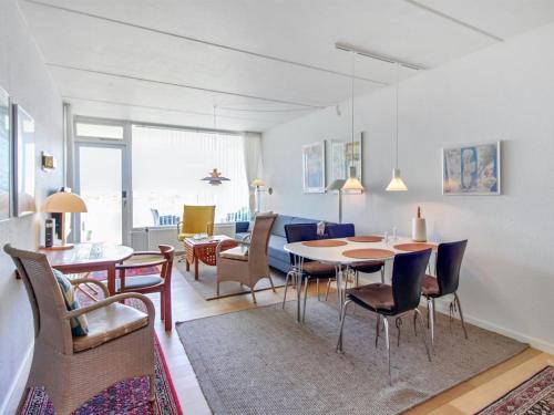 a living room and dining room with a table and chairs at Apartment Eske - 50m from the sea in Western Jutland by Interhome in Fanø