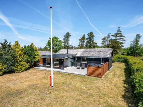 a house with a pole in a yard at Holiday Home Eira - 350m to the inlet in Western Jutland by Interhome in Tarm