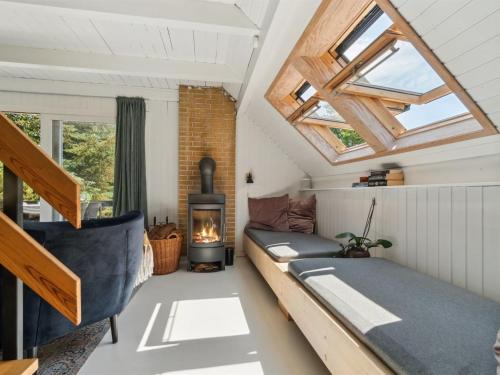 a room with a couch and a fireplace in a tiny house at Holiday Home Nadia - 300m to the inlet by Interhome in Fur