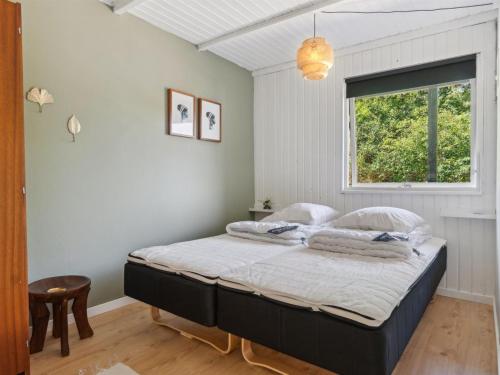 a bedroom with a bed in a room with a window at Holiday Home Nadia - 300m to the inlet by Interhome in Fur