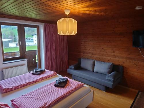 a living room with two beds and a couch at The Loft in Wagrain