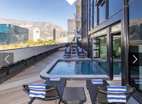 a swimming pool on the roof of a building at Onyx Studio Apartment in Cape Town