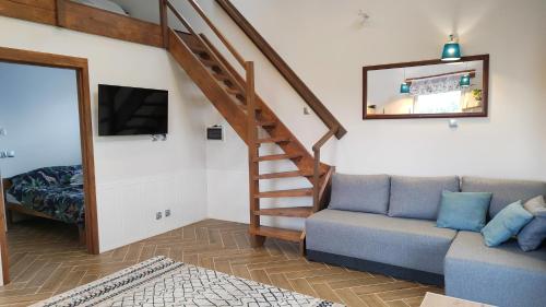 uma sala de estar com um sofá e uma escada em #MazuryOFFline em Giżycko