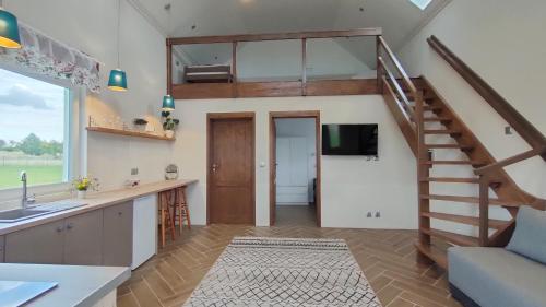 uma cozinha e sala de estar com uma escada em espiral em #MazuryOFFline em Giżycko
