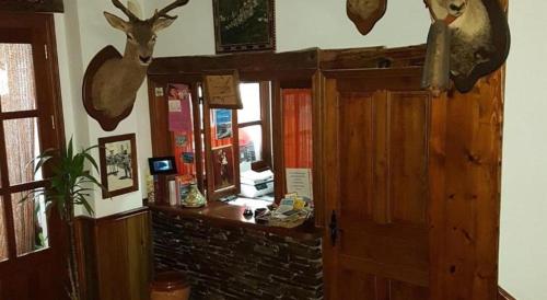 a room with a door and some deer heads on the wall at APARTAMENTOS SIETE LAGUNAS in Trevélez