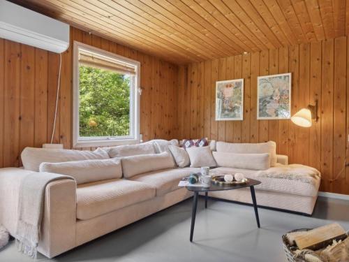 a living room with a couch and a table at Holiday Home Anya - 600m from the sea in NE Jutland by Interhome in Hals