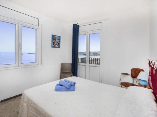 a white room with a table and two windows at Apartment Riells Platja by Interhome in L'Escala