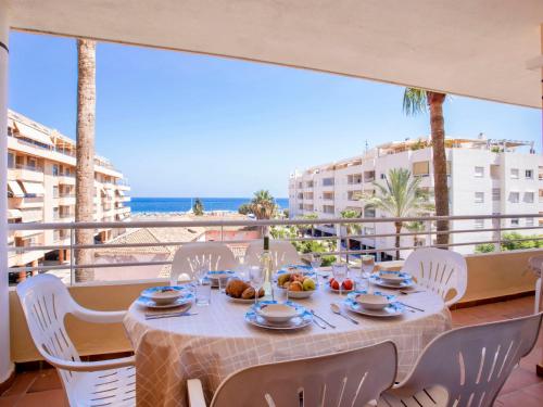 a table on a balcony with a view of the ocean at Apartment Dianium-1 by Interhome in Denia