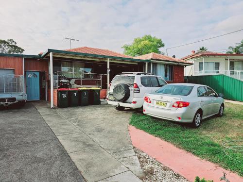 two cars parked in the driveway of a house at Kaban Power 7 in Doonside