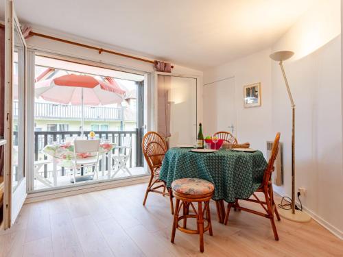 une salle à manger avec une table et des chaises et un balcon dans l'établissement Apartment Le Clos Mathilde-21 by Interhome, à Cabourg