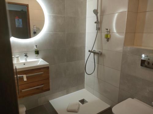 a bathroom with a shower and a toilet and a sink at Hotel Lou Granva in Grande Riviere