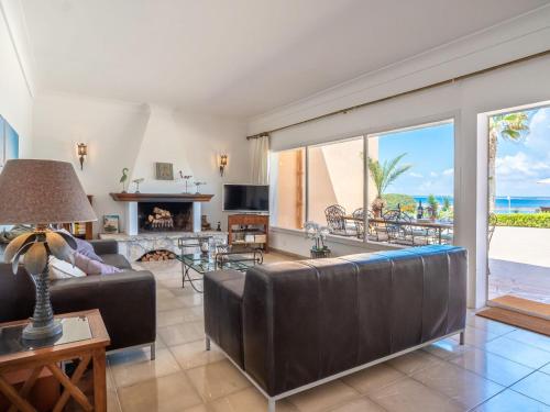 a living room with a couch and a fireplace at Holiday Home Las Gaviotas Style & Charm by Interhome in Colonia Sant Jordi