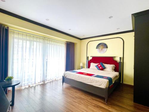 a bedroom with a bed and a large window at Moonlight Hotel Sa Pa in Sa Pa
