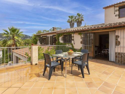 a patio with a table and chairs on a balcony at Holiday Home Can Maggi by Interhome in Calonge