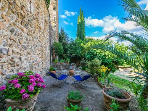 a patio with a table and chairs and flowers at Apartment Torre 4 by Interhome in Stigliano