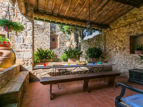 a patio with a table and a stone wall at Apartment Torre 4 by Interhome in Stigliano