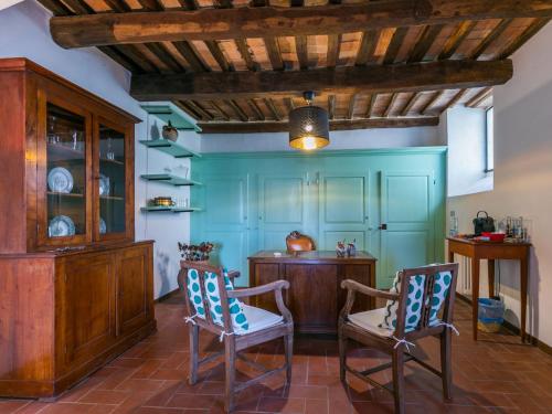 a kitchen with blue walls and two chairs and a table at Apartment Torre 4 by Interhome in Stigliano