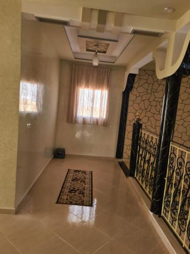 a room with a rug on the floor and a window at فيلا المصري in Chichaoua