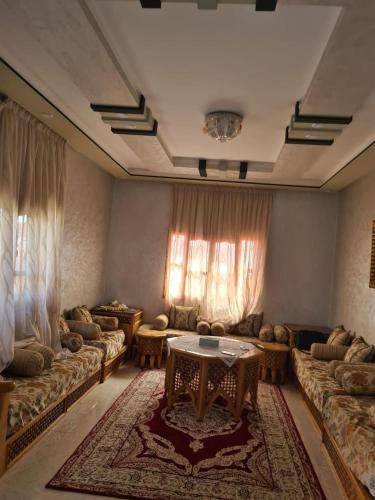 a living room with couches and a table at فيلا المصري in Chichaoua