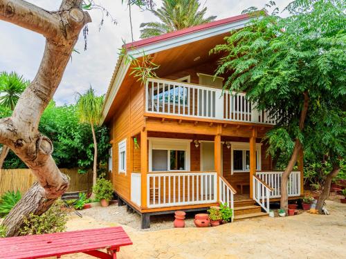 a wooden house with a porch and a bench at Holiday Home La Alqueria de Jordi by Interhome in El Grao