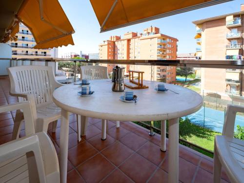 a white table and chairs on a balcony at Apartment Colom by Interhome in Malgrat de Mar