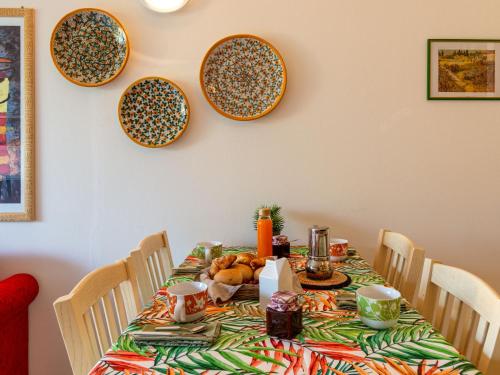 a dining room table with plates on the wall at Apartment Bot by Interhome in Gravedona