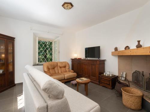 a living room with a couch and a fireplace at Holiday Home Lucrecia by Interhome in Calci