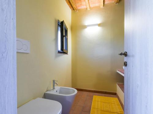 a bathroom with a white toilet and a sink at Holiday Home Podere San Fermo by Interhome in Roccastrada