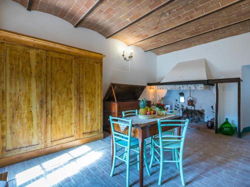 a kitchen with a wooden table and chairs at Apartment Torre 2 by Interhome in Stigliano