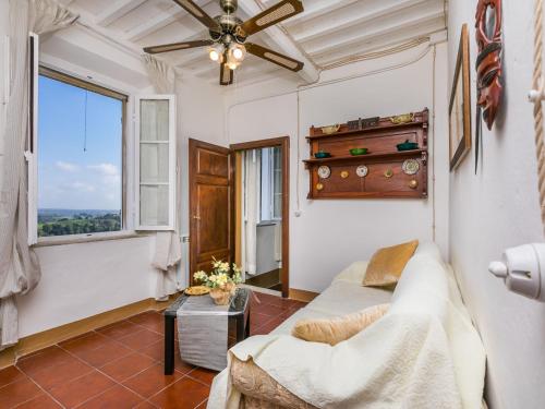 a living room with a couch and a window at Apartment Francesco's pretty house by Interhome in Riparbella