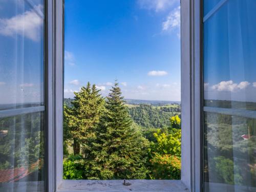 an open window with a view of trees at Apartment Francesco's pretty house by Interhome in Riparbella