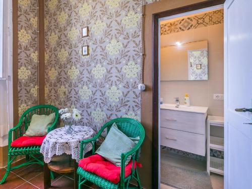 a bathroom with a table and two chairs and a sink at Apartment Francesco's pretty house by Interhome in Riparbella