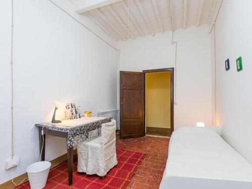 a bedroom with a desk and a bed and a table at Apartment Francesco's pretty house by Interhome in Riparbella