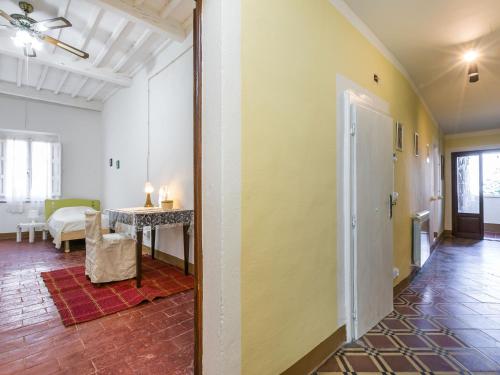 a hallway with a room with a table and a dining room at Apartment Francesco's pretty house by Interhome in Riparbella