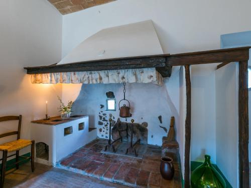 a room with a fireplace and a table and chair at Holiday Home La Torre-4 by Interhome in Stigliano