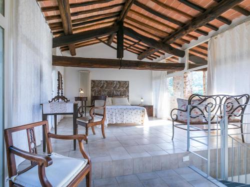 a living room with a bed and a table and chairs at Holiday Home La Torre-4 by Interhome in Stigliano