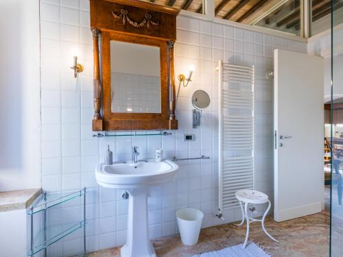 a bathroom with a sink and a mirror at Holiday Home La Torre-4 by Interhome in Stigliano