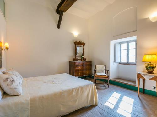a bedroom with a bed and a dresser and a window at Holiday Home La Torre-4 by Interhome in Stigliano