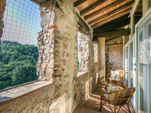 a porch with two chairs and a window at Holiday Home La Torre-4 by Interhome in Stigliano