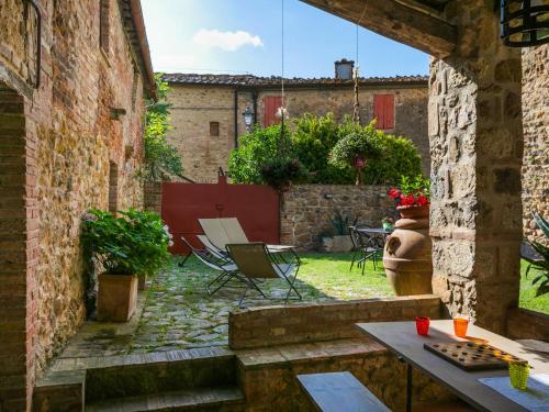 an outdoor patio with a table and chairs in a courtyard at Holiday Home La Torre-4 by Interhome in Stigliano