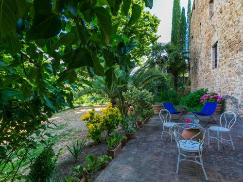 a patio with chairs and tables and plants at Holiday Home La Torre-4 by Interhome in Stigliano